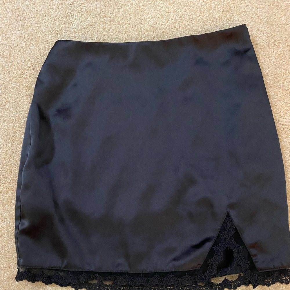 Black silky mini skirt, with lace mesh.